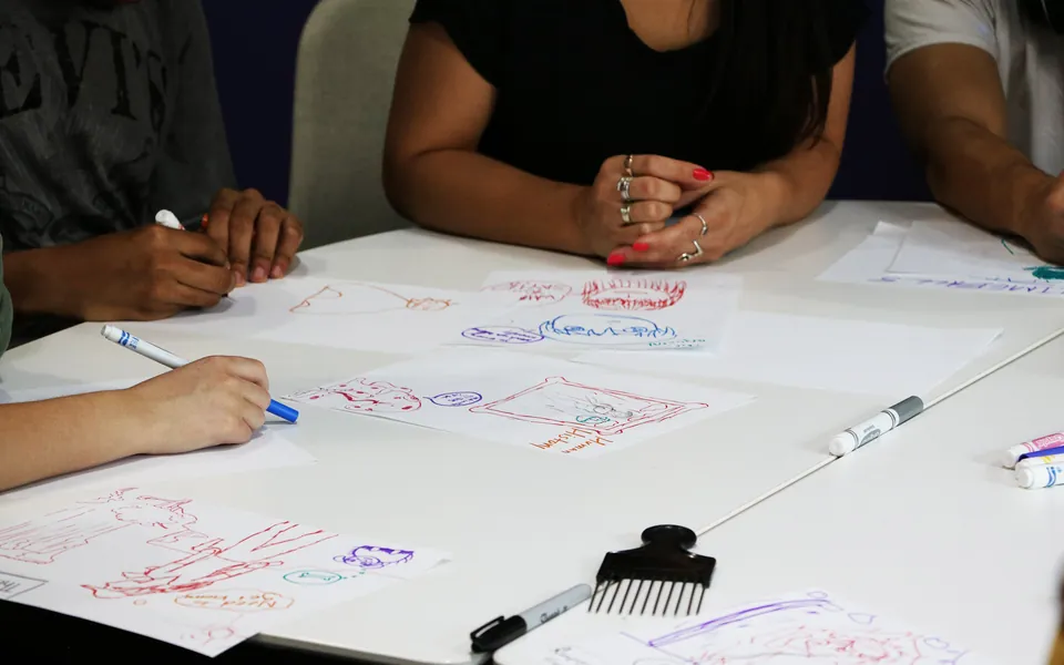 Hands sketching storyboards on paper
