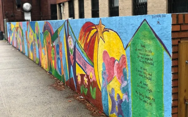 A colorful mural along a building wall